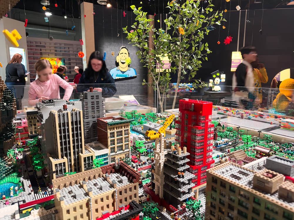 Visitors building a LEGO city skyline